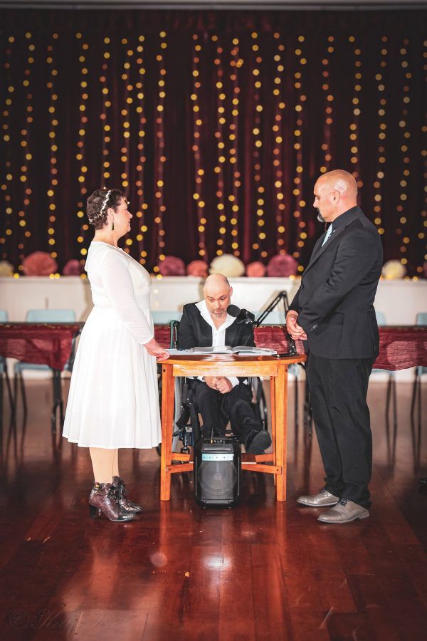 Gray leading an indoor ceremony